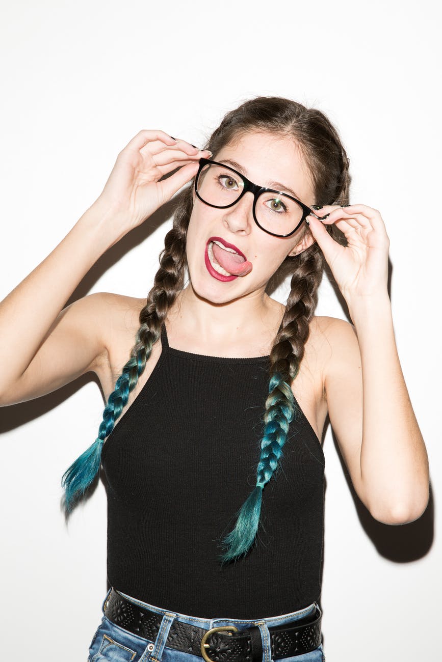 woman holding her eyeglasses