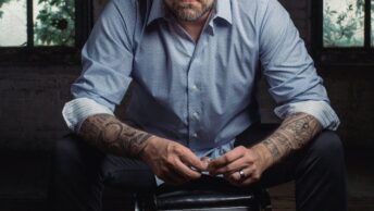 man sitting on black leather padded chair