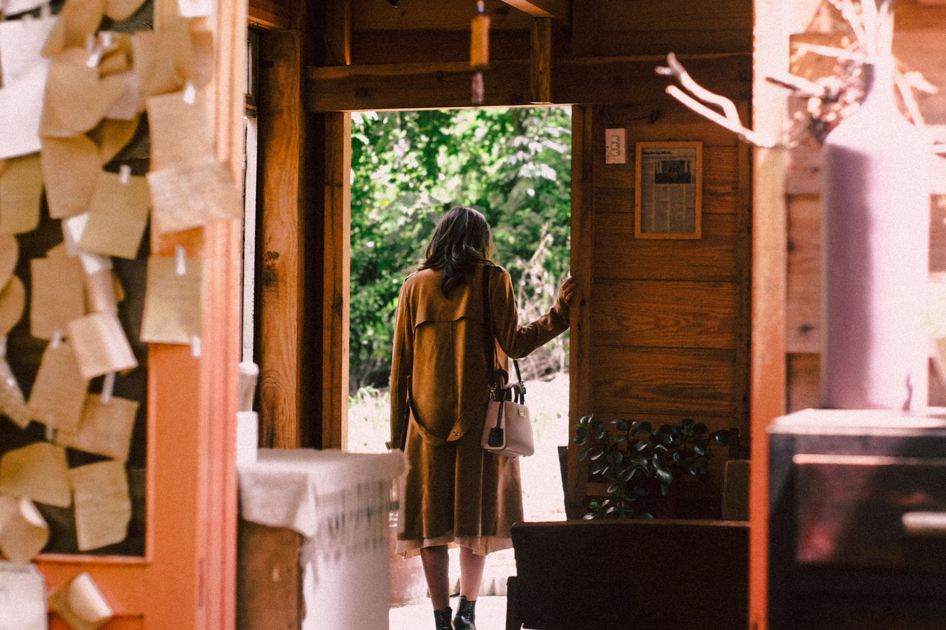 woman standing near open door about to step outside